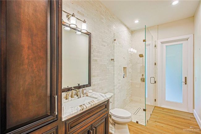 Full bathroom with a stall shower, porcelain floors, vanity, and recessed lighting, limestone tile | Image 27