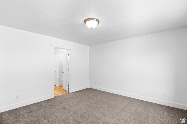 (Picture of Previously Build Home) Carpeted spare room featuring baseboards and a textured ceiling | Image 10