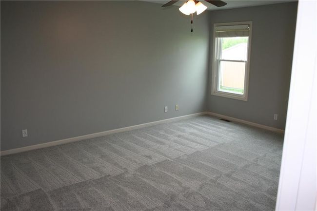 Carpeted empty room featuring baseboards and ceiling fan | Image 8