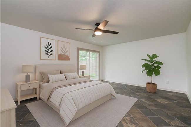 Virtually staged primary bedroom on first floor. | Image 6