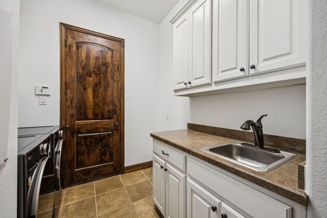Laundry area with cabinet space and washing machine and dryer | Image 6