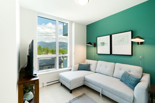 Living area featuring baseboard heating and carpet | Image 13