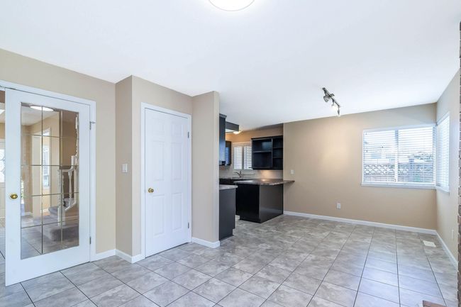 Kitchen featuring baseboards, rail lighting, a sink, and light tile patterned floors | Image 14