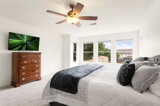 Oversized primary bedroom featuring new carpet, fresh paint, large windows, and a bright, airy atmosphere with ample natural light. | Image 30