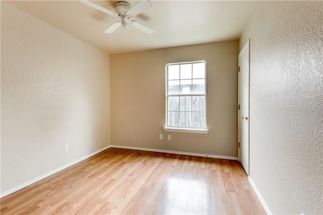 Unfurnished room featuring a textured wall, light wood-type flooring, and ceiling fan | Image 6