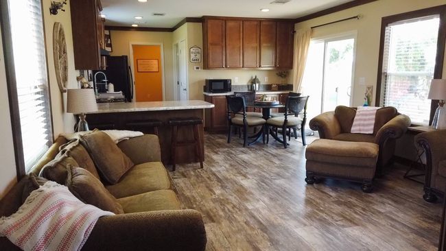 Living area with crown molding, wood finished floors, and recessed lighting | Image 25