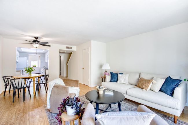 Living room with light wood-type flooring and a ceiling fan | Image 10