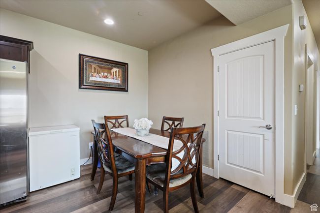 Dining room with dark wood-type flooring, visible vents, recessed lighting, and baseboards. Freezer not included. | Image 6