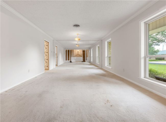 Spare room with ornamental molding, carpet floors, and a textured ceiling | Image 9