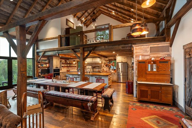 1920's sourced chestnut frame graces the main floor, loft ceiling rafters and the wide plank floors lending unique warmth and beauty throughout | Image 22