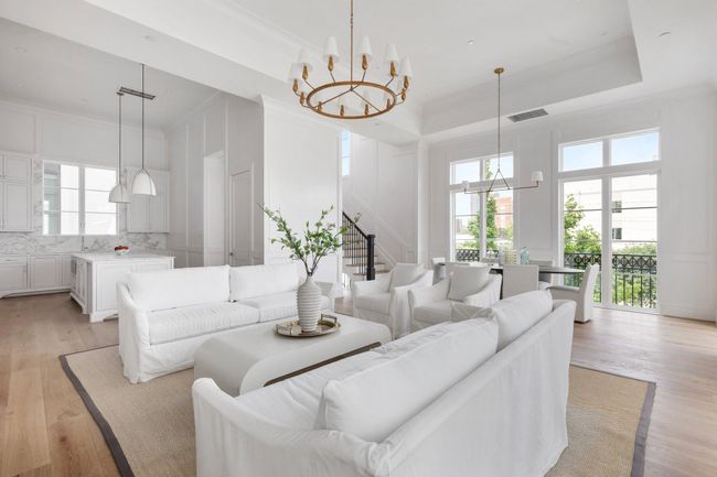 The natural light drawis attention to layered architectural trim and designer wood paneling that define the space with elegance. | Image 11