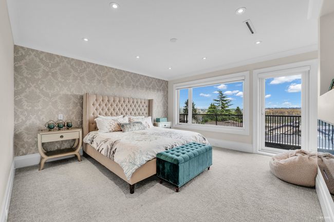 Bedroom featuring visible vents, carpet, baseboards, wallpapered walls, and access to outside | Image 39