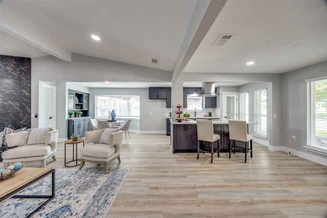 Living area featuring light wood-type flooring, healthy amount of natural light, and recessed lighting | Image 9