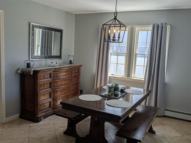 Full dining room with a chandelier andtile floors | Image 12