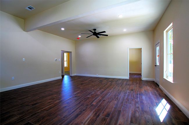 Spare room with dark wood-style floors, a ceiling fan, recessed lighting, and baseboards | Image 4