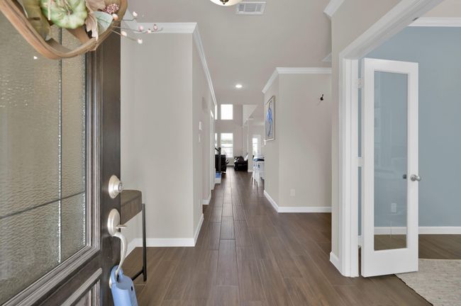 You've arrived... and are immediately greeted with wood-look tile, a neutral color palette, and a view straight back to the heart of the home and an impressive open layout. | Image 4