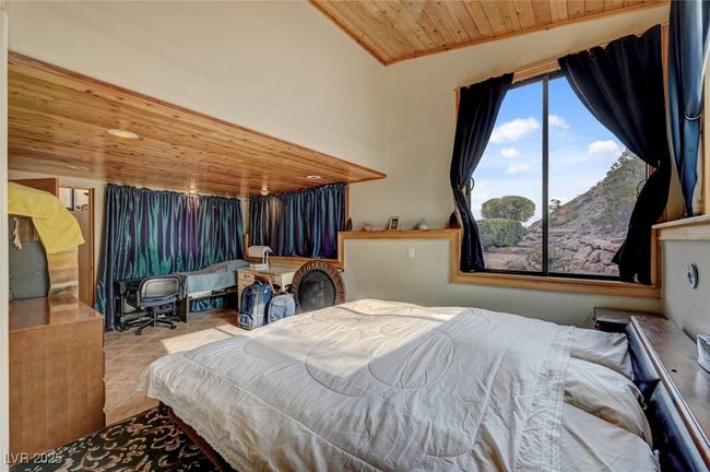 Tiled bedroom with wood ceiling and lofted ceiling | Image 42