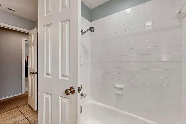Bathroom with shower / tub combination and tile patterned floors | Image 27
