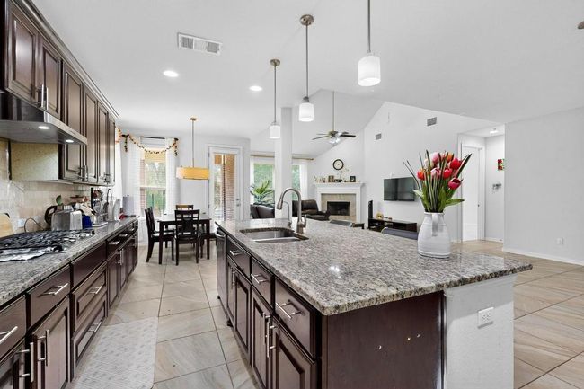 Staircase featuring arched walkways, washer / dryer, a towering ceiling, ceiling fan, and recessed lighting | Image 12