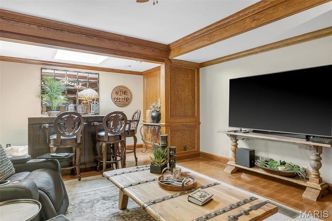 Living area with a skylight, light wood-type flooring, and crown molding | Image 53
