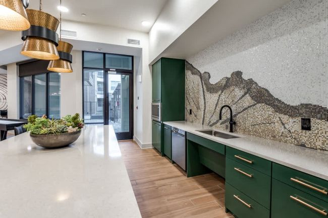 Kitchen featuring green cabinets, dishwasher, sink, and decorative backsplash | Image 35
