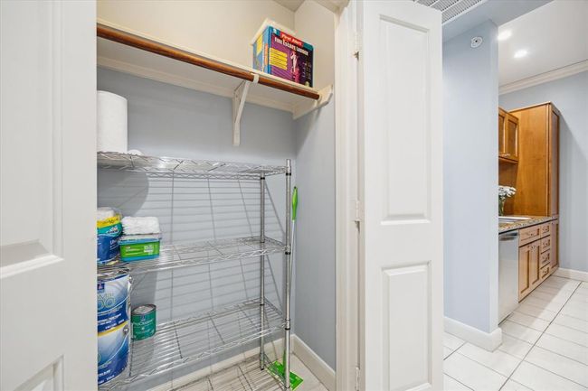 Neatly organized hall storage area, complete with metal shelves rack. This practical space offers ample room for storing additional items, helping keep the living area tidy and clutter-free. | Image 17