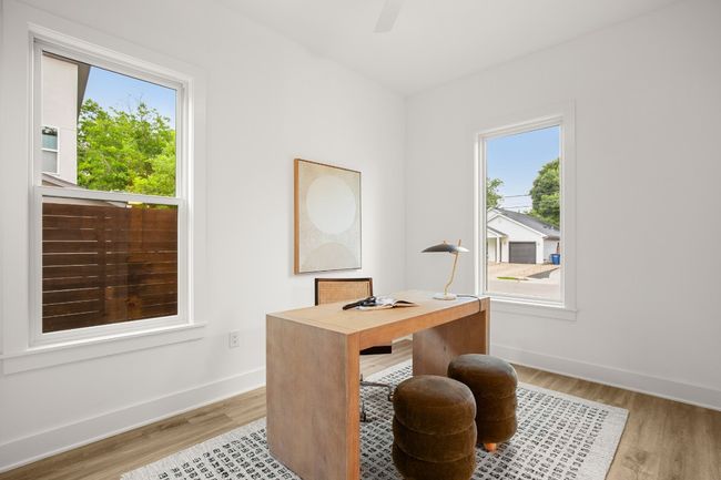 Home office featuring light wood-type flooring, a ceiling fan, and baseboards | Image 11