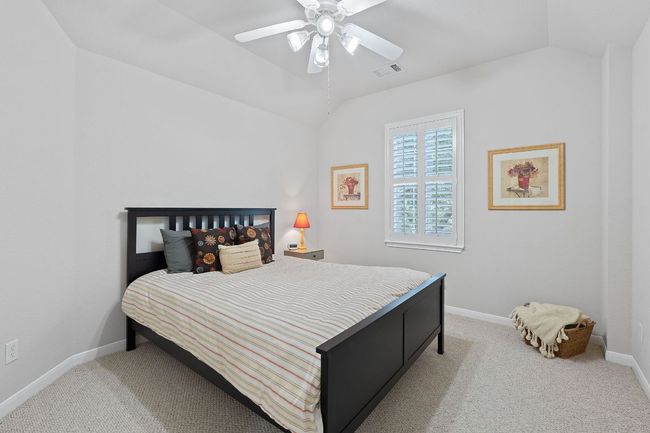 Bedroom with vaulted ceiling, carpet, baseboards, and ceiling fan | Image 17