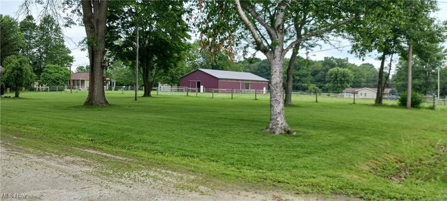 View of yard with a pole building and an outbuilding | Image 27