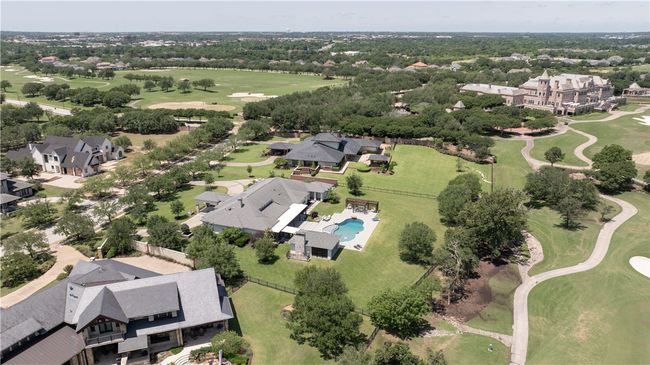 Aerial view of property and surrounding area with a local golf course, a pool area, and nearby suburban area | Image 34