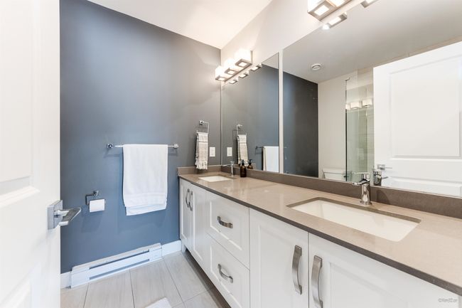 Full bathroom featuring baseboards, a sink, toilet, and a baseboard radiator | Image 23