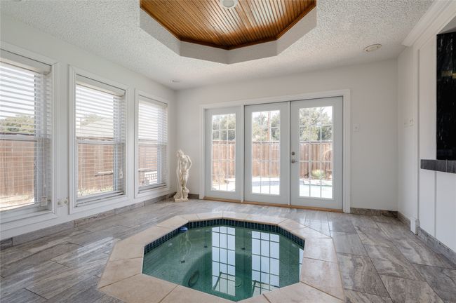 Hot tub room overlooking pool area and bar | Image 10