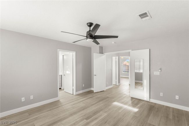 Unfurnished bedroom with baseboards, a ceiling fan, visible vents, and light wood-style flooring | Image 24