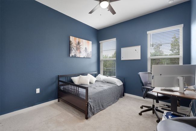 Bedroom with carpet, a desk, and a ceiling fan | Image 31