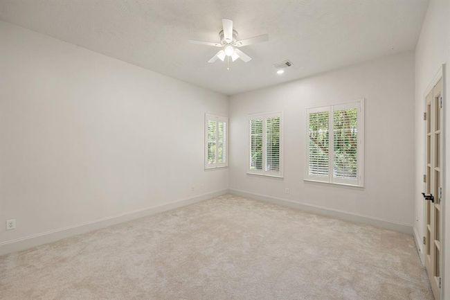 Another secondary bedroom upstairs with a Juliet balcony. This room faces the front of the home. | Image 37