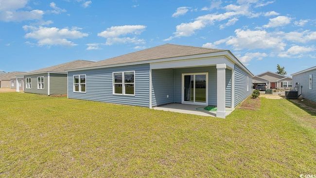 Back of property featuring a patio area, a lawn, and central air condition unit | Image 24