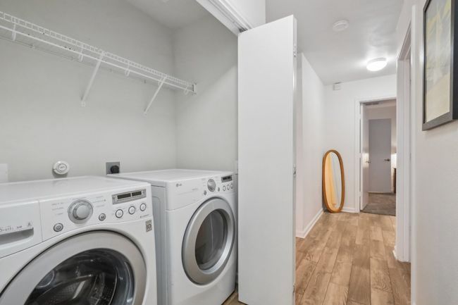 Laundry room with baseboards, laundry area, light wood finished floors, and washer and dryer | Image 13