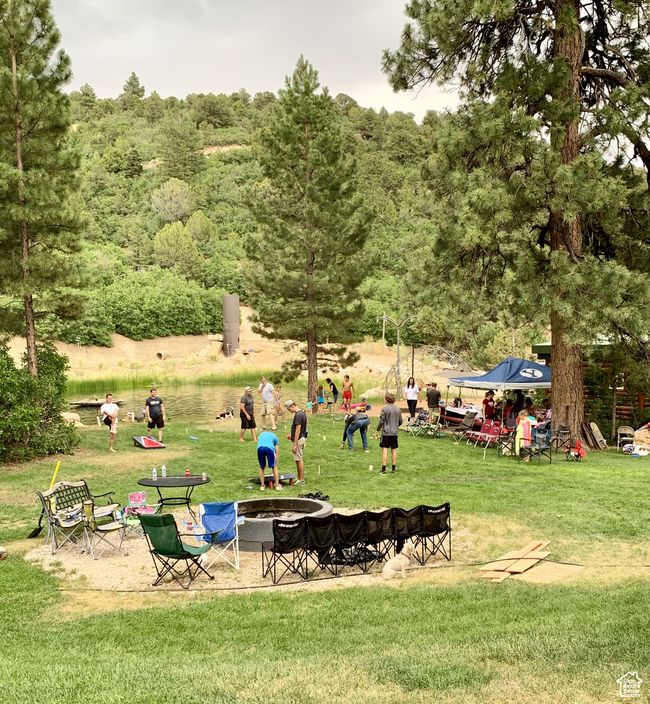 View of community featuring an outdoor fire pit and a lawn | Image 14