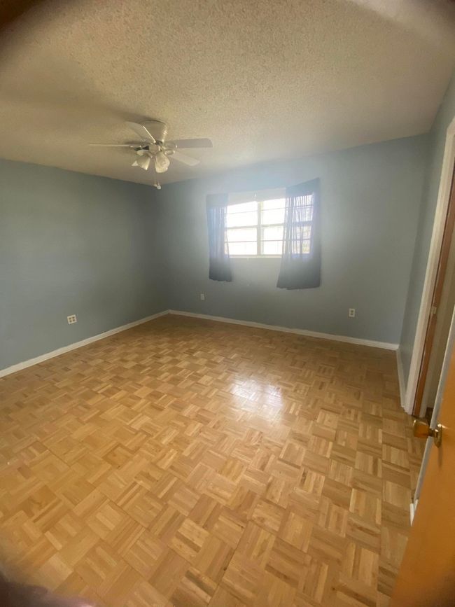 Empty room with a textured ceiling and baseboards | Image 9