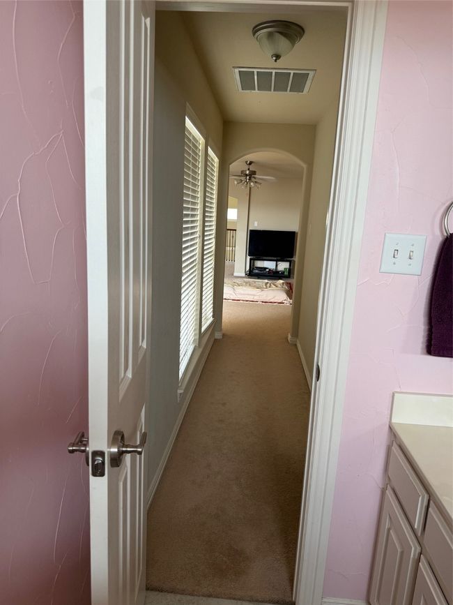 Hall with carpet floors, arched walkways, and baseboards | Image 40
