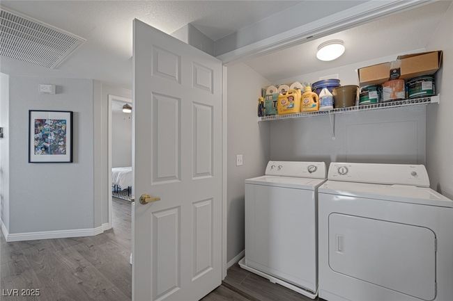 Washroom featuring visible vents, laundry area, dark wood finished floors, and washer and clothes dryer | Image 23