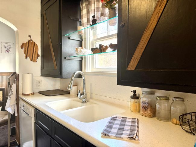 Kitchen with light countertops, dishwasher, and a sink | Image 11
