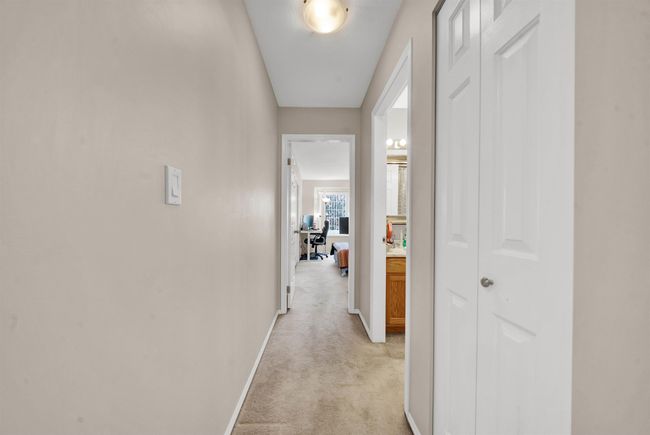 Bedroom with light carpet, a closet, and baseboards | Image 32