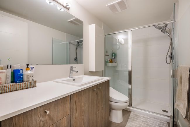 Bathroom featuring vanity, a shower stall, and tile patterned flooring | Image 14