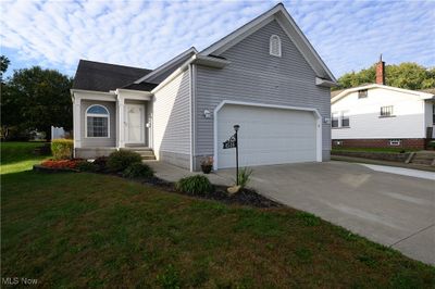 View of front facade featuring a garage and a front lawn | Image 1