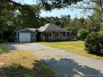 Single story home with a garage and a front yard | Image 1