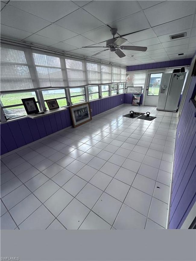 Unfurnished sunroom with a drop ceiling and ceiling fan | Image 15