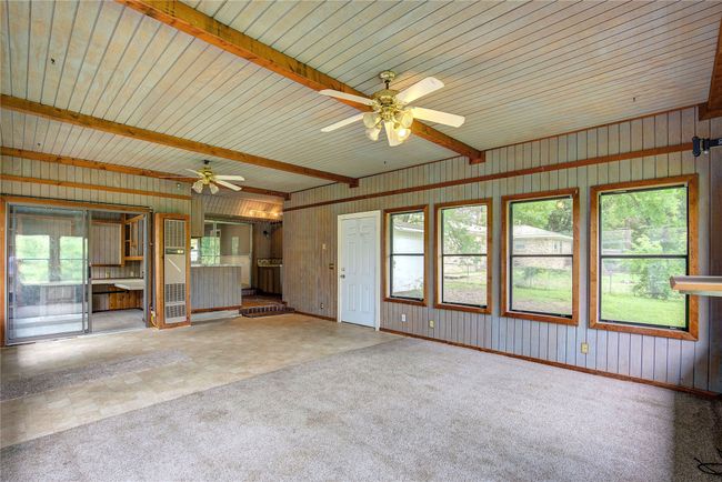 Unfurnished Bonus Roomfeaturing a ceiling fan, beam ceiling, carpet floors, and wood walls | Image 17