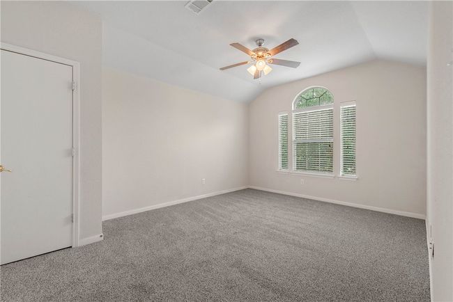 Carpeted spare room with lofted ceiling and a ceiling fan | Image 13