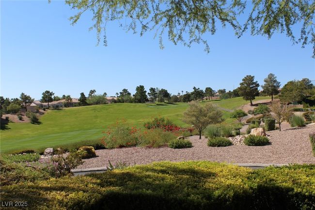 View of property's community featuring a lawn and view of golf course | Image 30